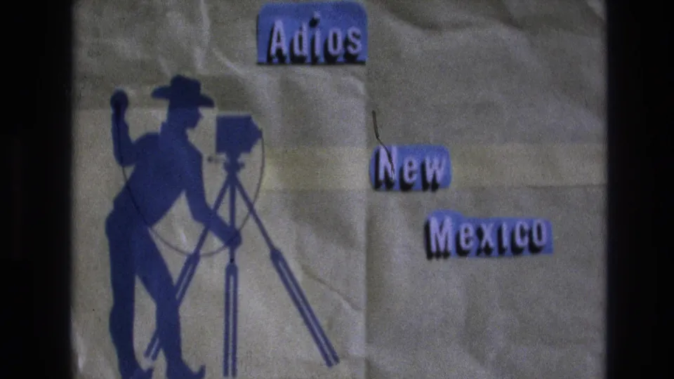 Final 1973 New Mexico home-movie title-card frame with a blue cowboy camera silhouette on the left and purple “Adios New Mexico” text on a textured background.