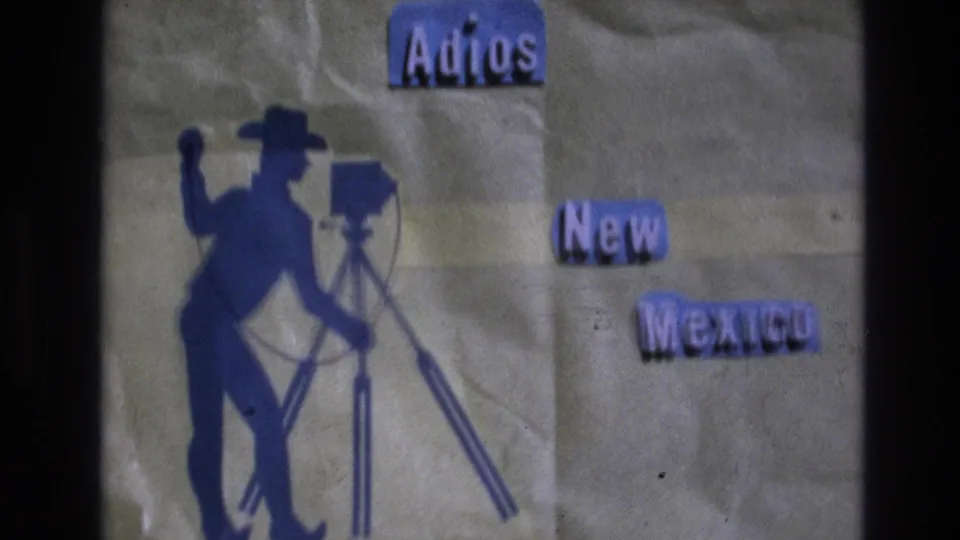 Final 1973 New Mexico title-card frame with the Adios heading, New Mexico text, blue cowboy photographer silhouette, tripod camera, and visible home-movie grain.