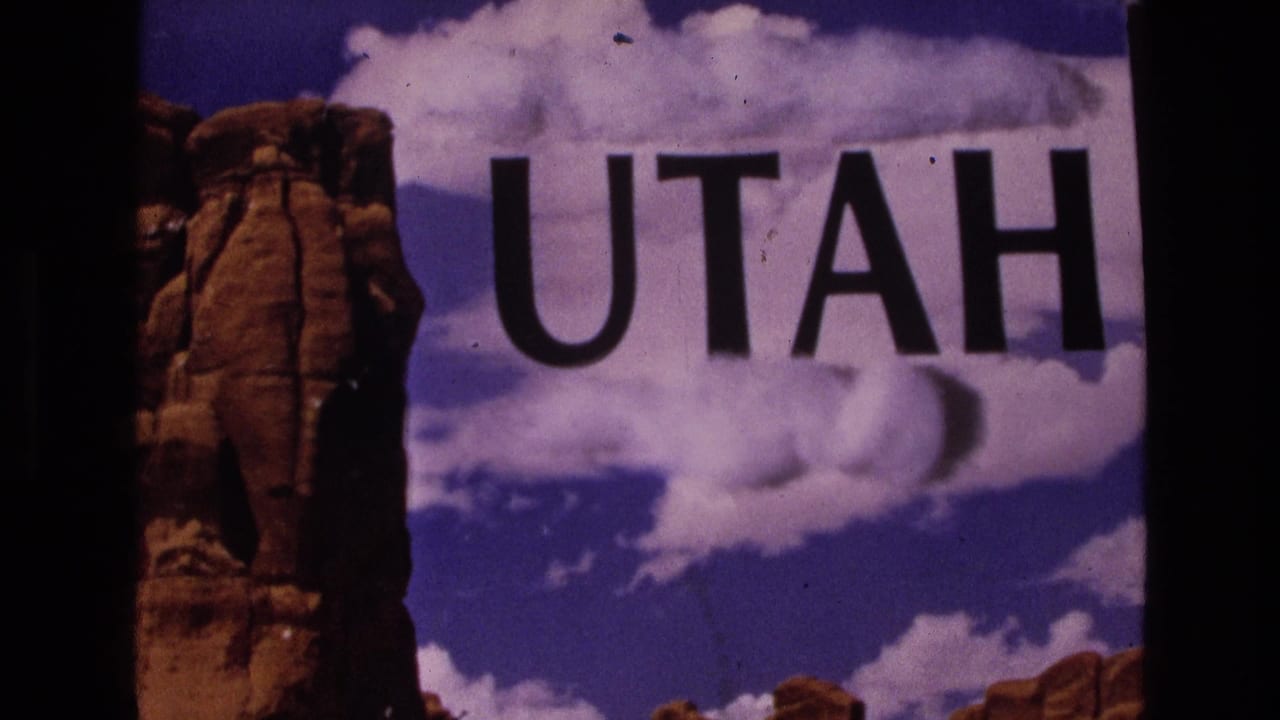 Large UTAH text appears over a cloudy sky beside a tall red rock formation.