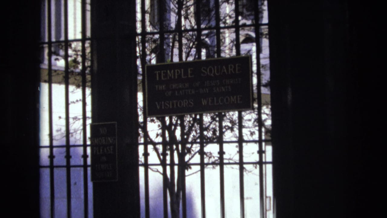 Closer view of the Temple Square visitors welcome sign behind gate bars.