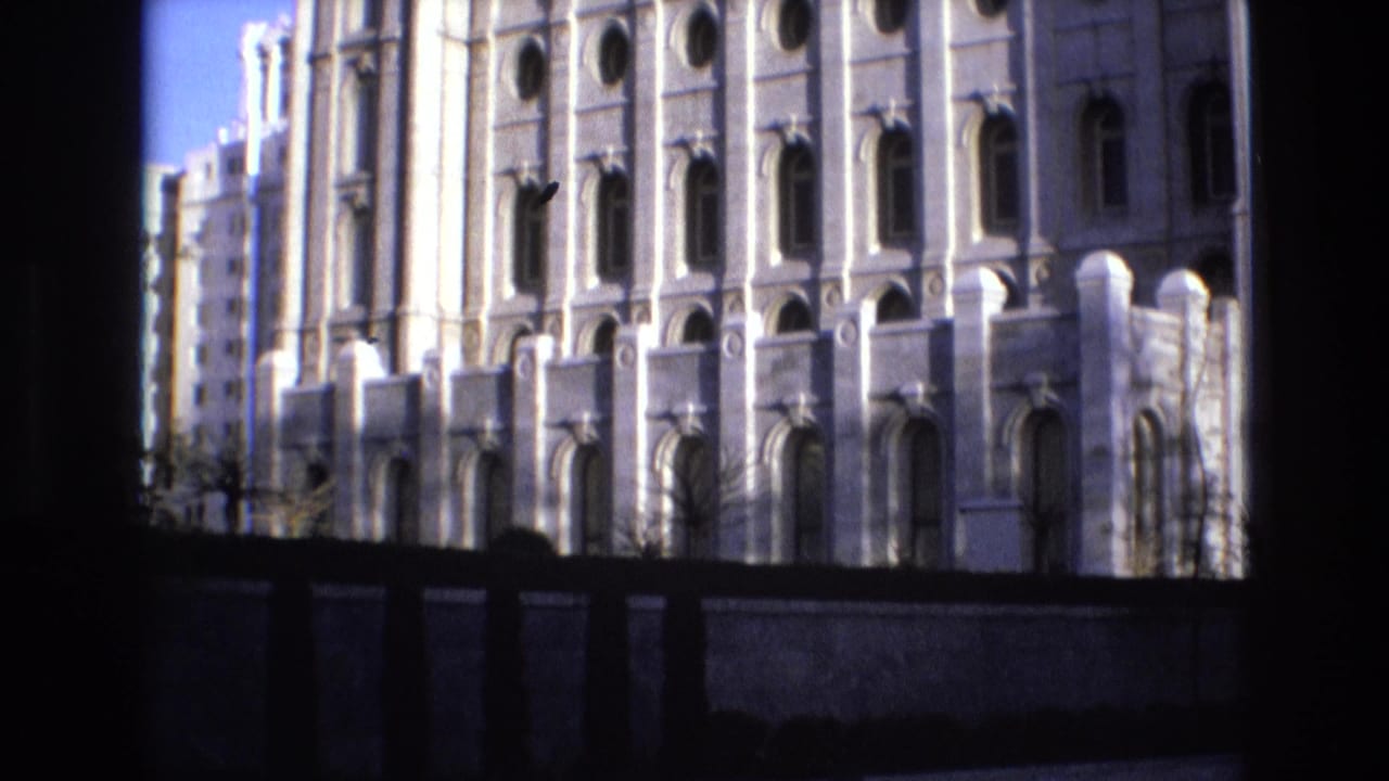 Temple facade with arched windows seen through a dark foreground frame.