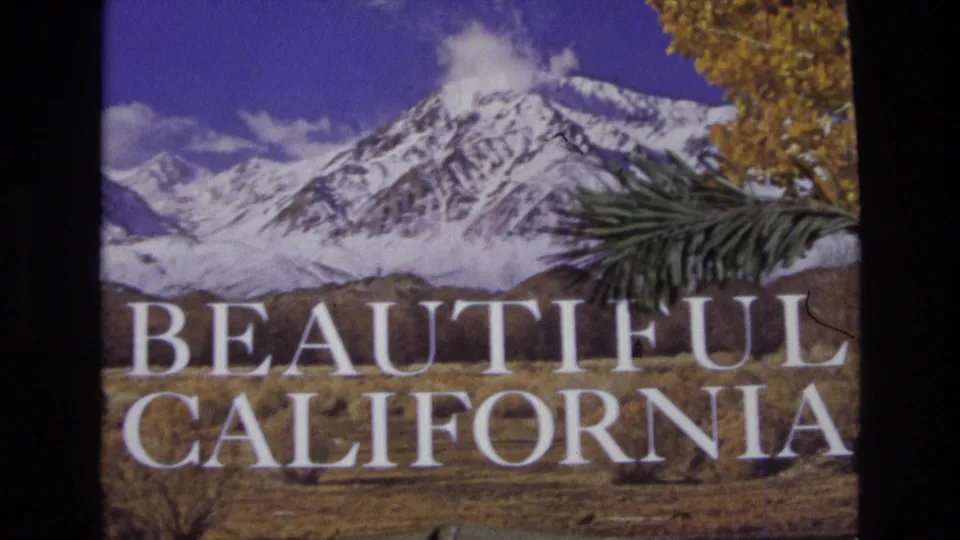 1973 8mm-style California landscape frame with a snow-capped peak, blue sky, golden autumn foliage, foreground pine branch, and prominent Beautiful California lettering.