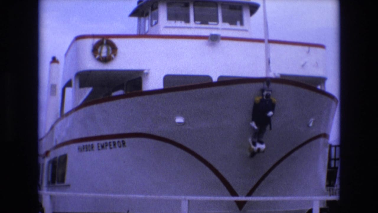White Harbor Emperor boat bow with a dark diver figure hanging near the front.