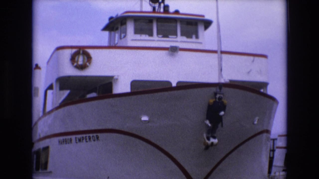White passenger vessel bow with Harbor Emperor name visible near the hull.