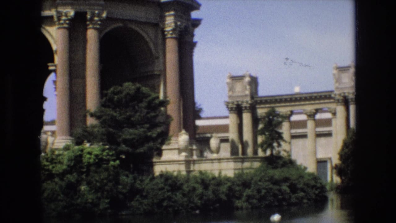 Palace of Fine Arts columns and facade behind dense greenery.