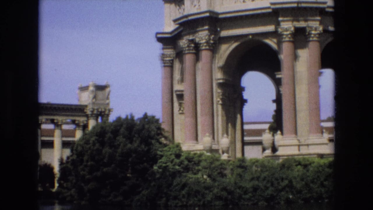 1973 San Francisco footage showing a closer visitor view of the Palace of Fine Arts rotunda columns and arch above trees and a lake edge.