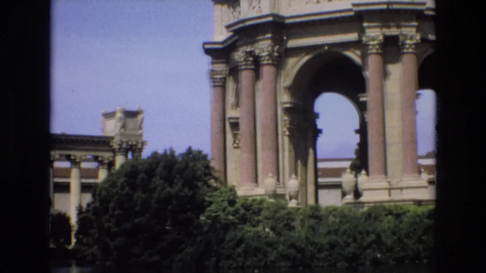 1973 San Francisco footage showing a closer visitor view of the Palace of Fine Arts rotunda columns and arch above trees and a lake edge.