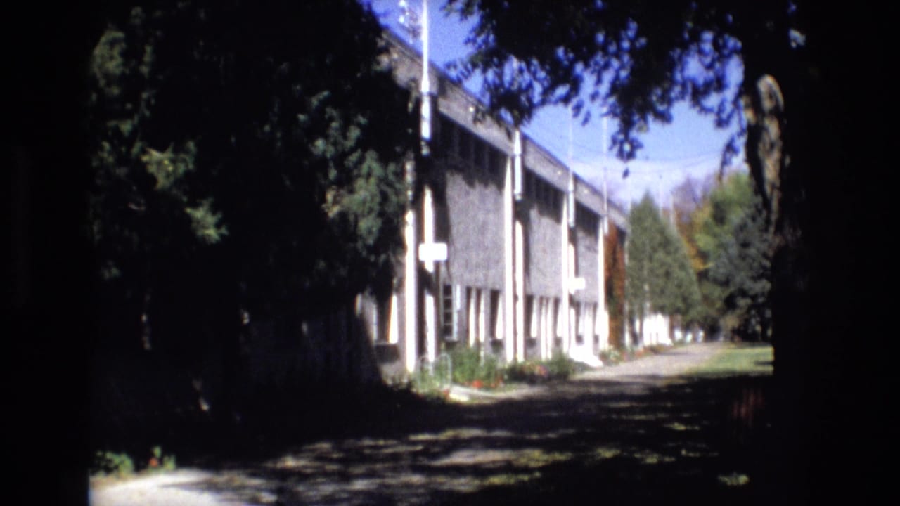 Similar shaded view of the building and path under a bright sky.