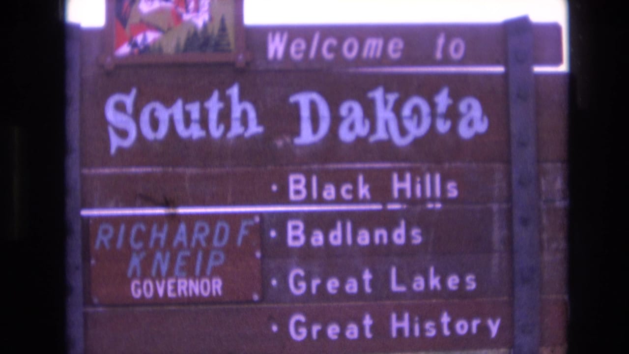 South Dakota welcome sign with tourism text and a Governor Kneip panel.