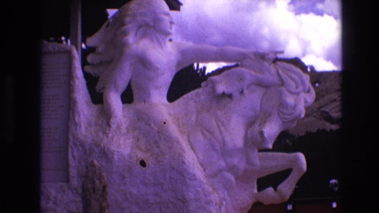 Close view of the white rider-and-horse statue with the rider pointing forward.