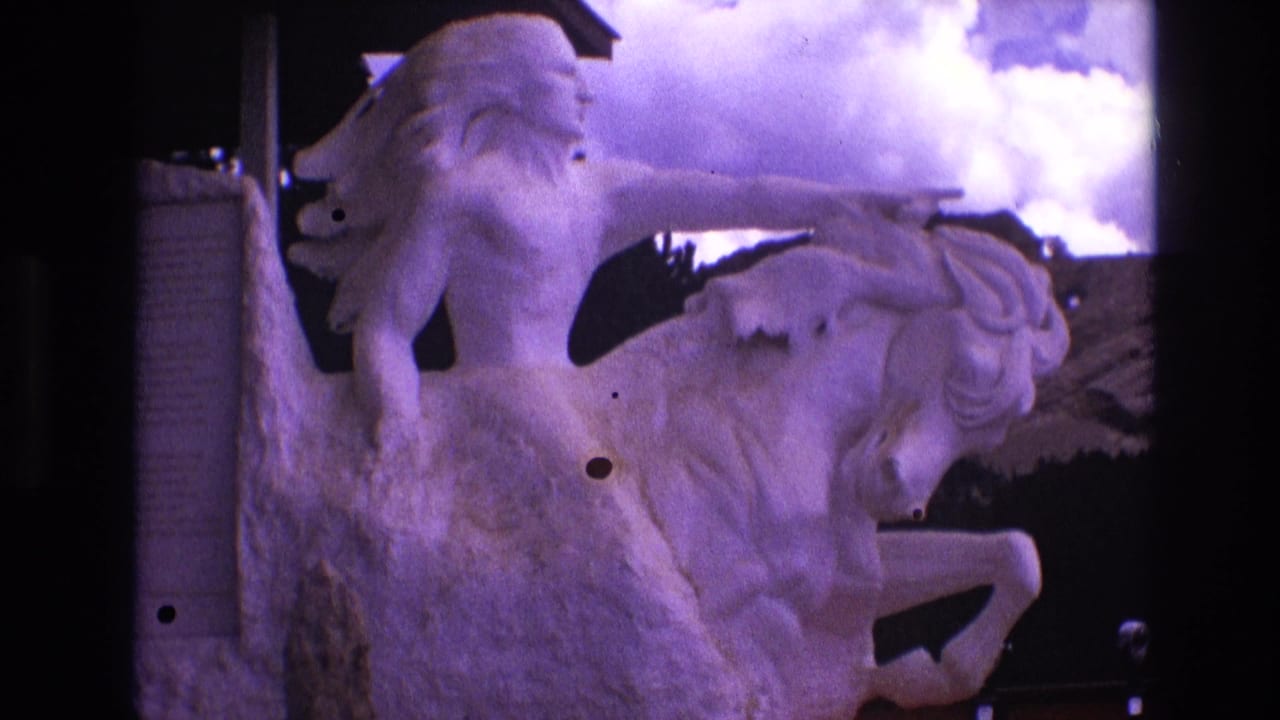 Close view of the horse-and-rider statue with clouds behind it.