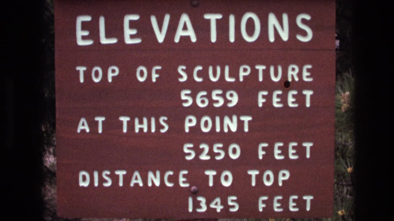 Elevations sign fills the frame with trees along the side.