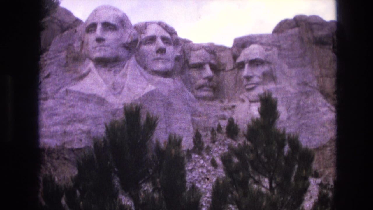 Four Mount Rushmore faces framed by pine branches and dark 8mm film edges.