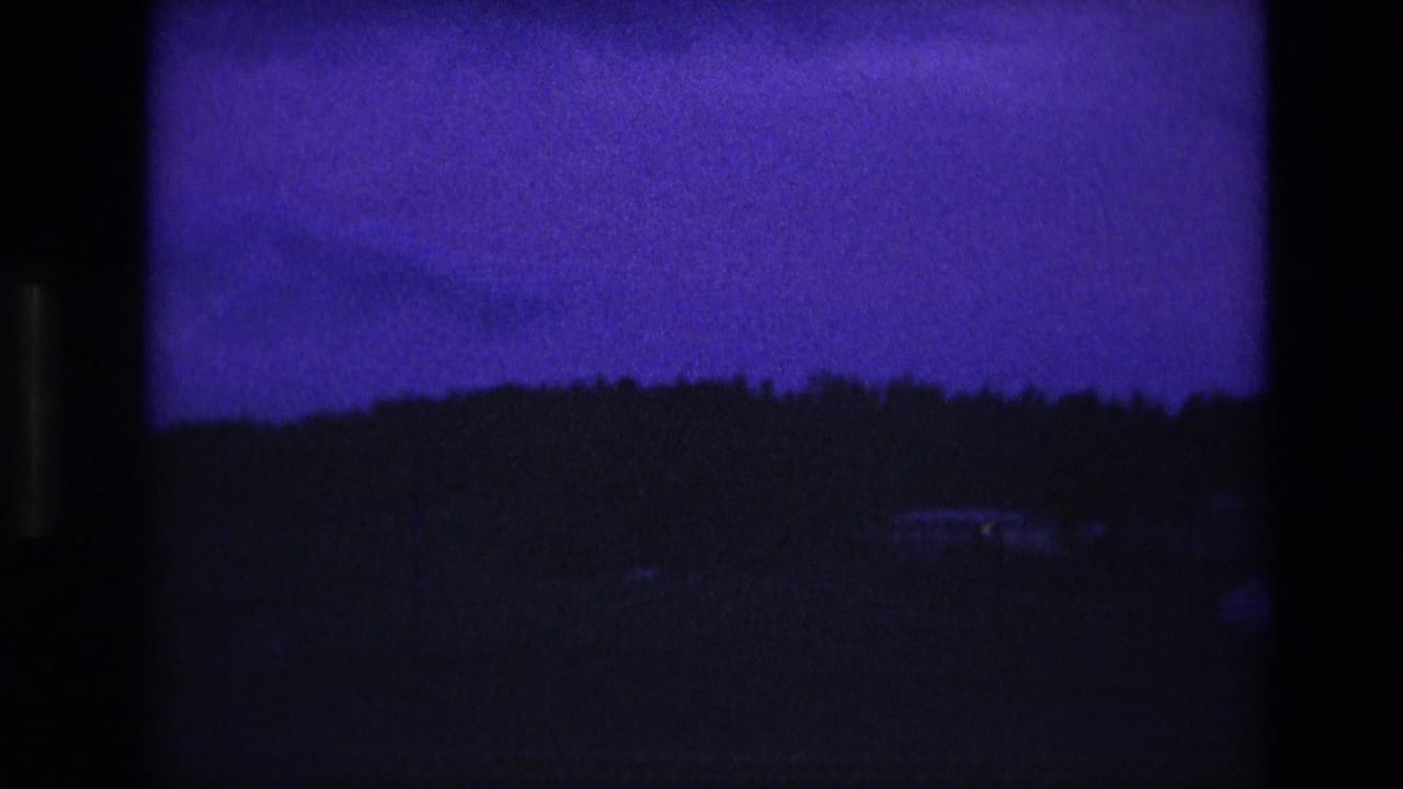 Very dark horizon silhouette beneath a deep blue-purple sky.