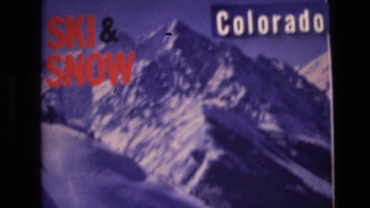 1974 Vail, Colorado home-movie frame showing a photographed ski-and-snow travel poster with red “SKI & SNOW” text, white “Colorado” lettering, and a purple-tinted mountain illustration.