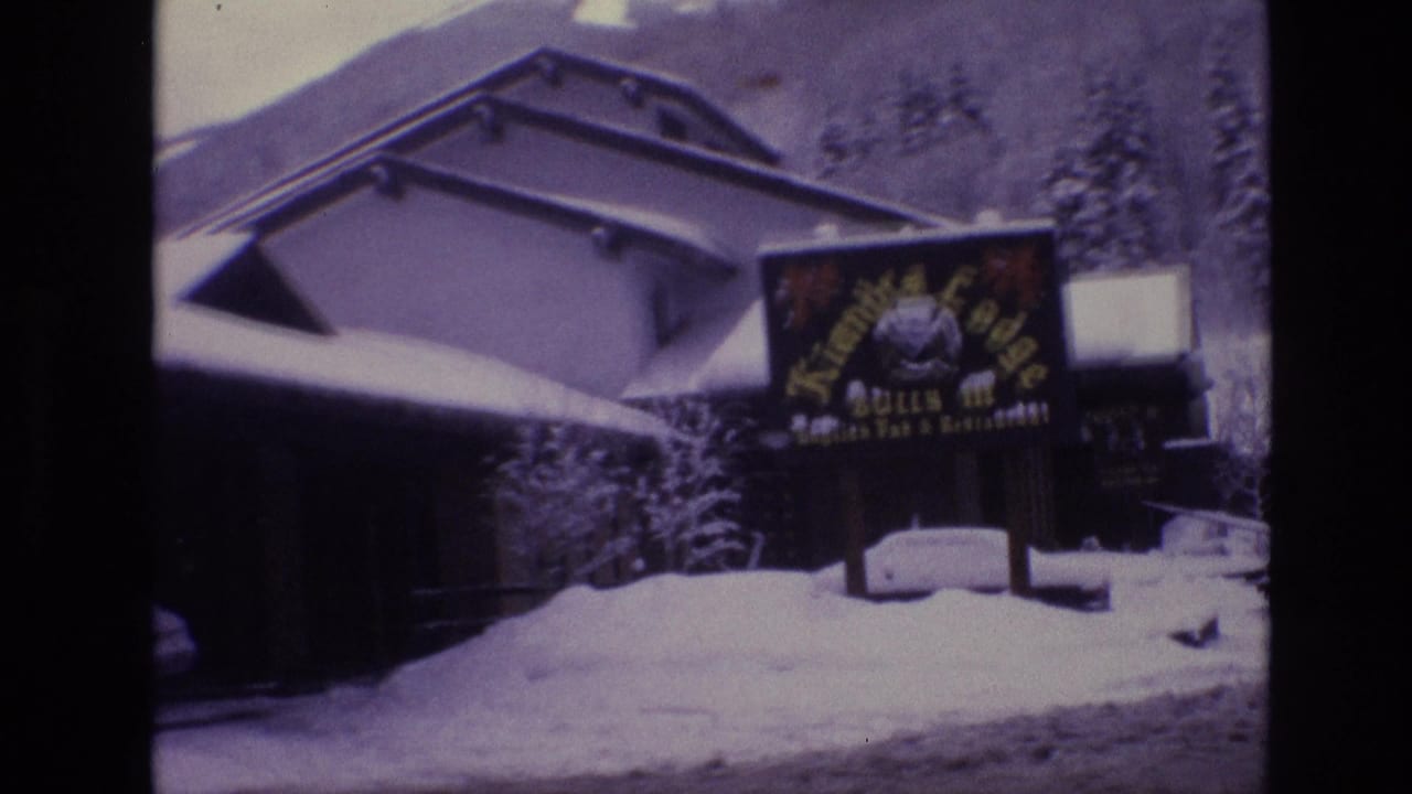 1974 Vail, Colorado home-movie frame showing the Kiandra Lodge sign on a snow-covered lodge exterior with evergreen trees and ski-slope terrain behind it.