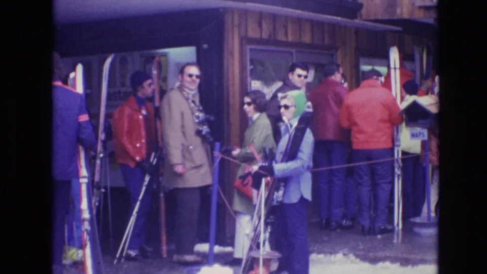 The final frame shows adults in a Vail ski-lodge queue in 1974, with colorful coats, sunglasses, skis, poles, snow, and a small map sign visible.