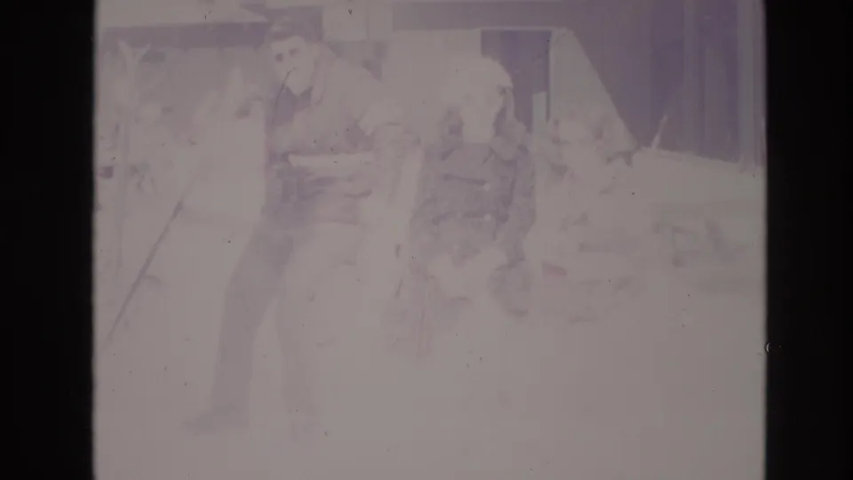 Adults appear to wait together in snowy Vail resort surroundings, with faded 8mm color and a building facade behind them.