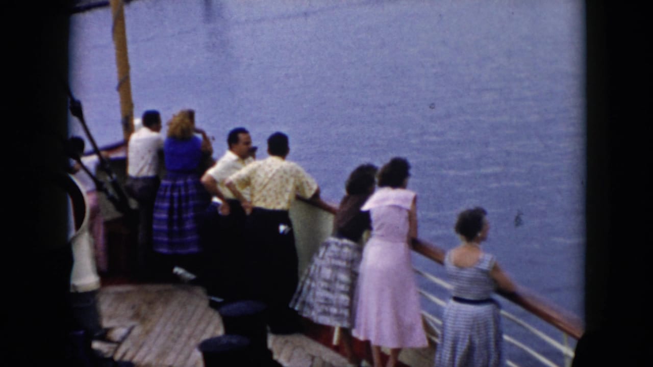 1956 Cuba travel footage shows adults in mid-century clothing gathered along a cruise ship railing facing the sea.