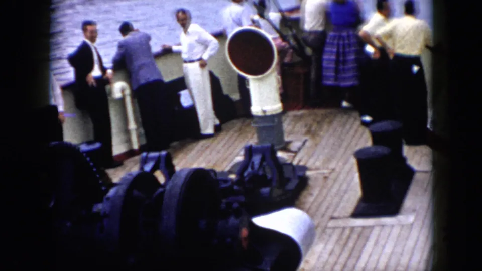 The later frame shows passengers and deck equipment from above, with adults gathered near the rail and water behind them.