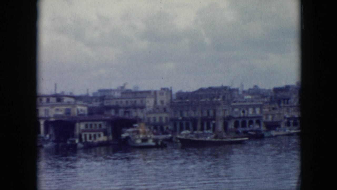 Harbor shoreline with boats, arched facades, and dense waterfront buildings.