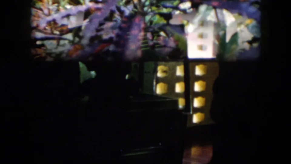 Final frame shifts to a dark scene with silhouetted figures and glowing rectangular areas, possibly an interior display or exhibit space.