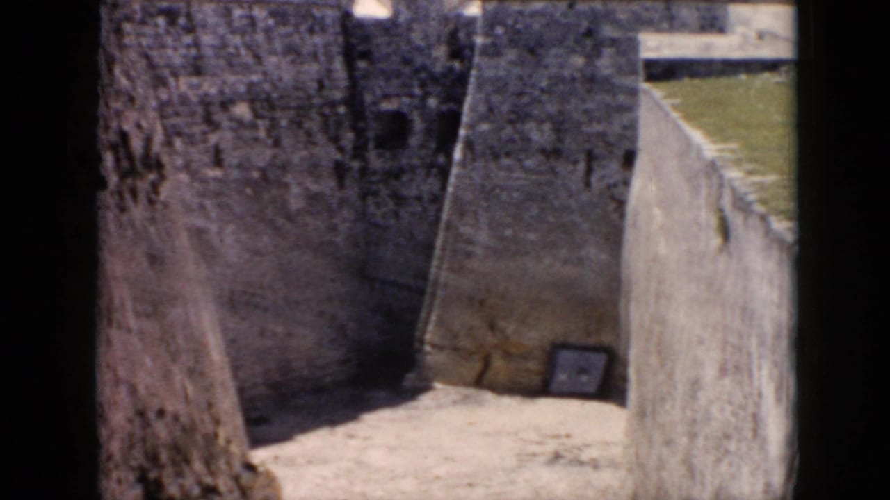 Closer view of a fort passage between high weathered masonry walls.