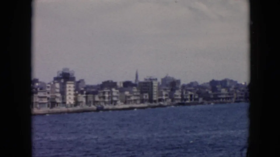 The Cuba waterfront remains in view at the end of the shot, showing low urban buildings beyond rippled harbor water.