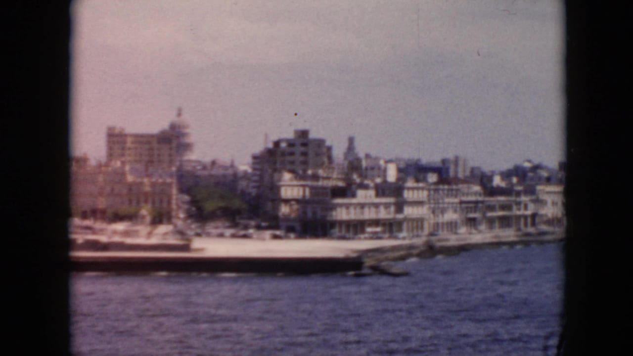 Waterfront buildings and harbor water seen from a boat.