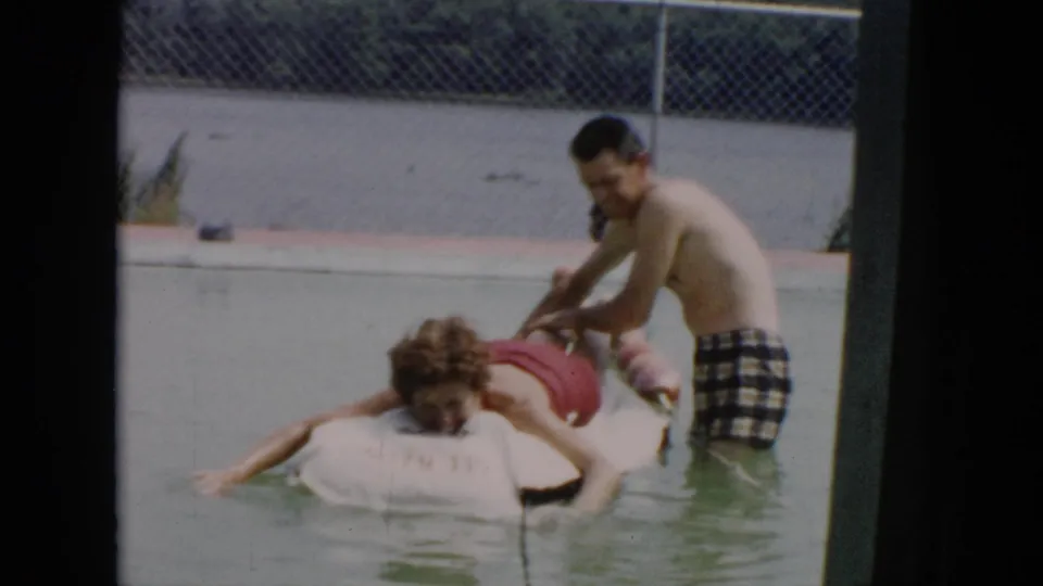 At the end of the 1956 Cuba clip, the man on the raft stretches an arm into the water while the other remains beside him.