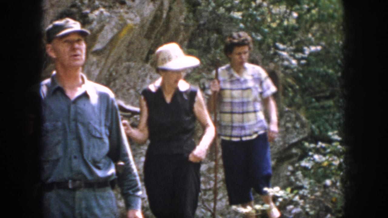 Three older adults hike through a rocky wooded area in metadata-supported 1958 Dayton, Ohio footage.