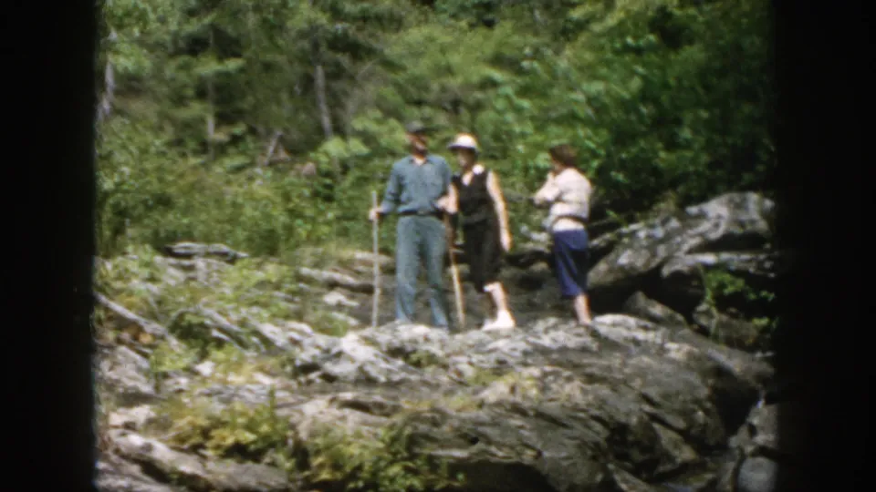 The group continues across rocky stream terrain in this 1958 Dayton, Ohio 8mm home-movie frame.