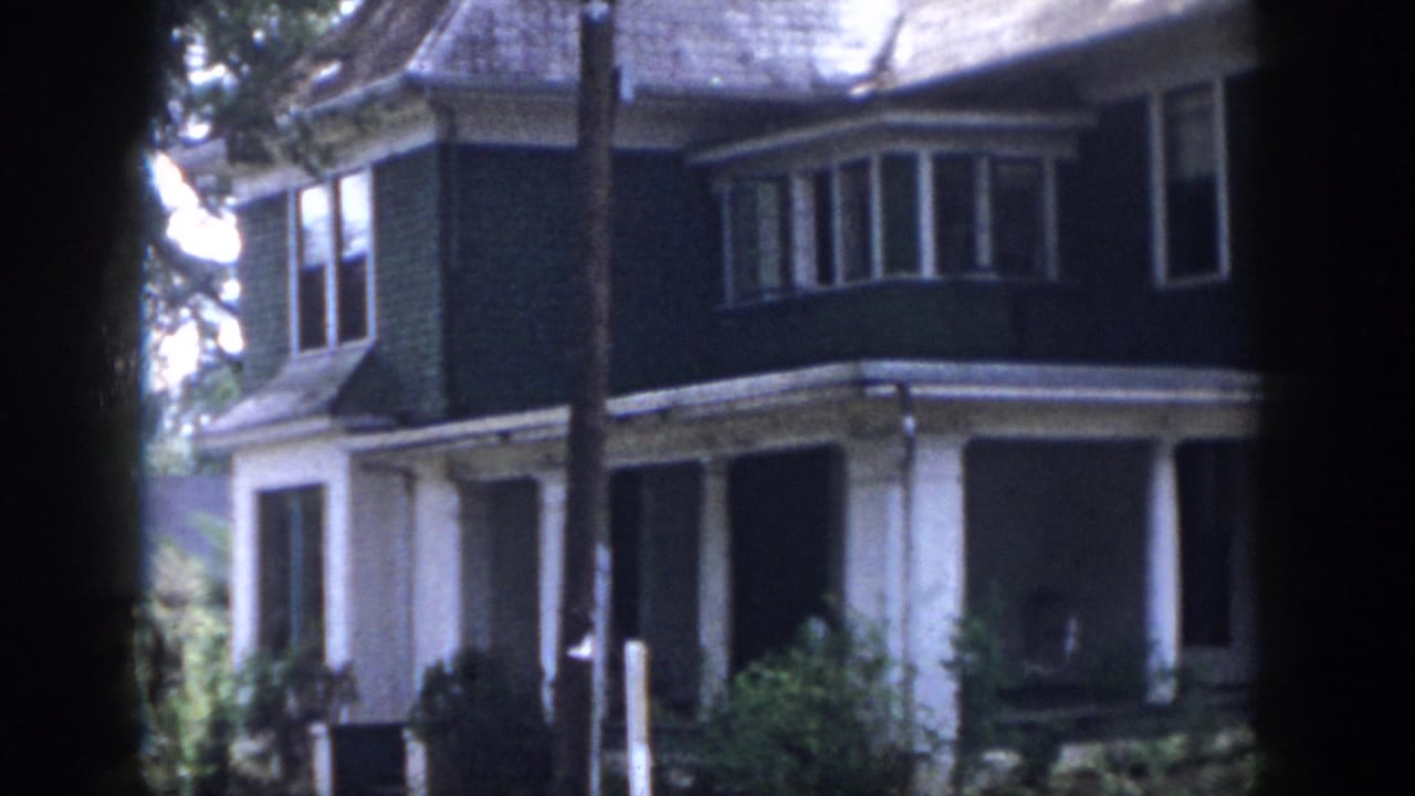 Closer view of the same house exterior with porch and bay window.