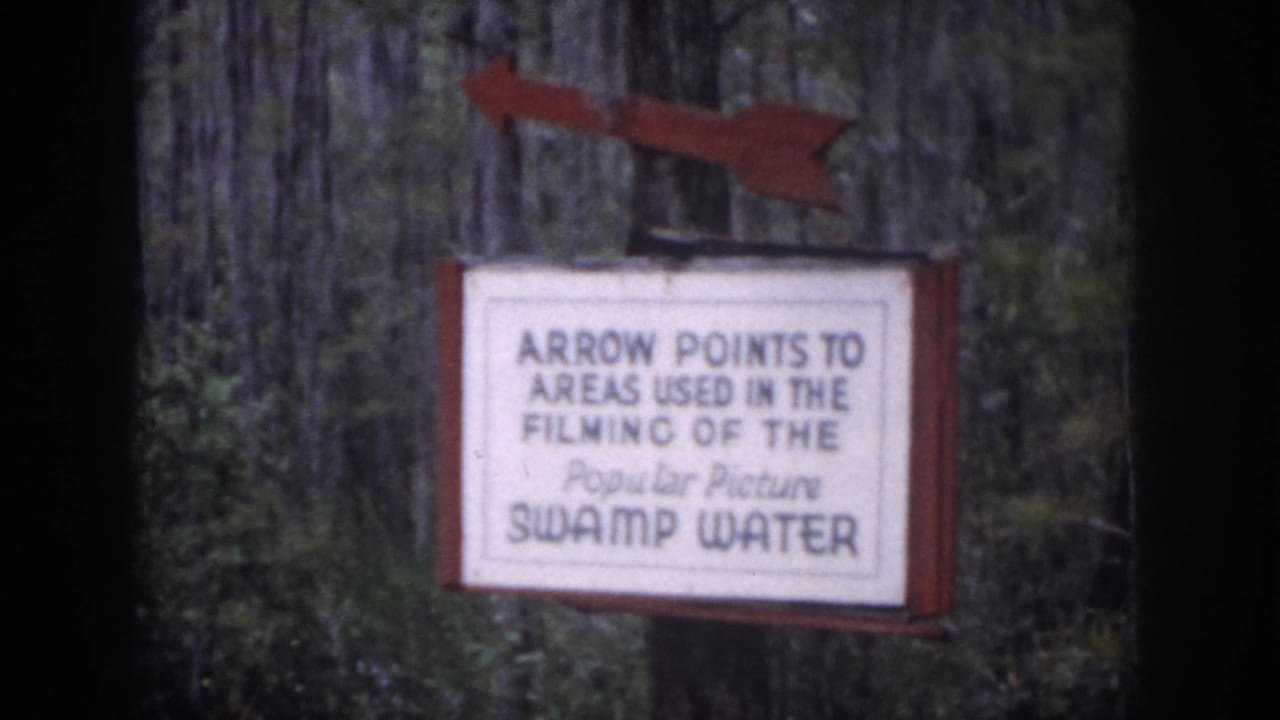 1958 Dayton, Ohio frame showing a red arrow above a sign referencing areas used in filming Swamp Water.