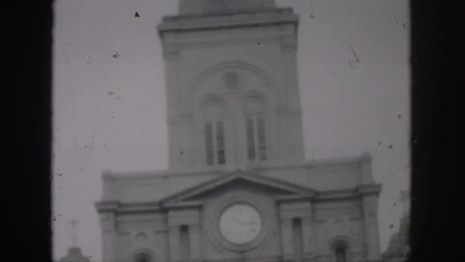 1958 New Orleans frame of a church clock tower and arched upper windows, with heavy film borders and soft exposure.
