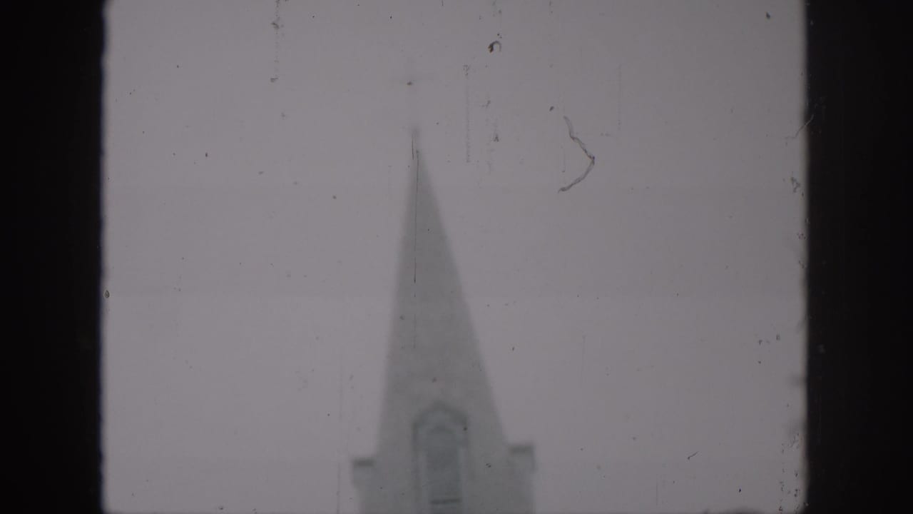 Cathedral steeple partly visible beside a dark vertical film-frame border.