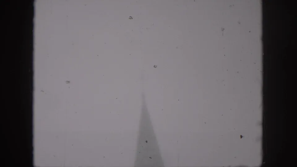 A faint cathedral spire is barely visible in the lower frame of this soft 1958 New Orleans 8mm shot.