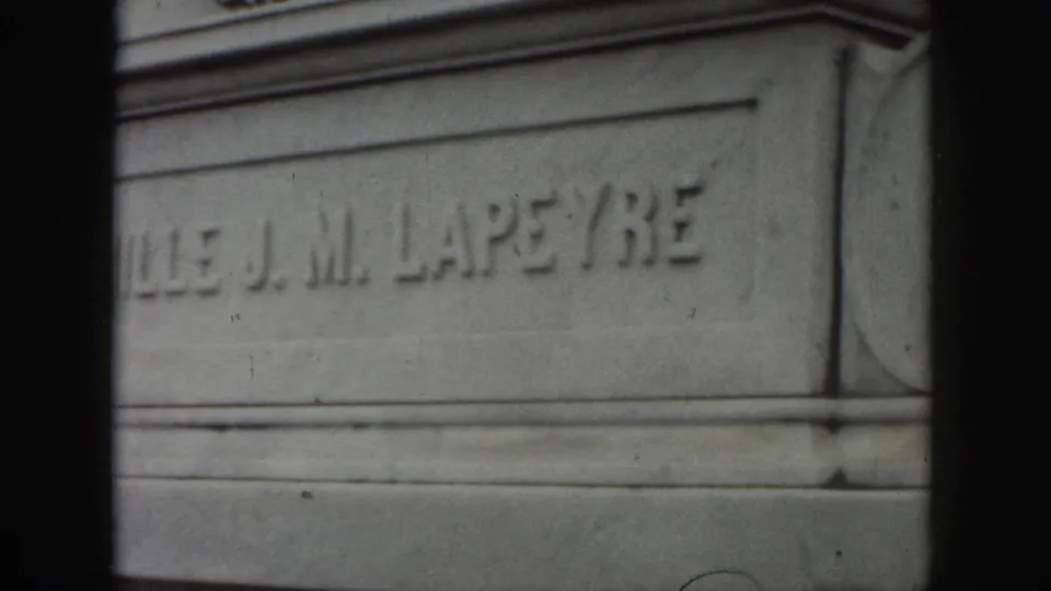 1958 New Orleans cemetery frame showing a close view of the “J. M. LAPEYRE” inscription on a weathered stone tomb.