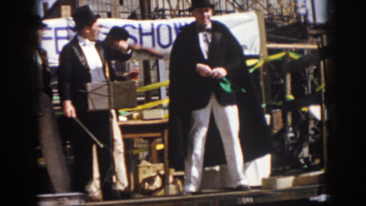 1958 Virginia parade float showing men in tuxedo-style clothing and top hats beside props and a banner.