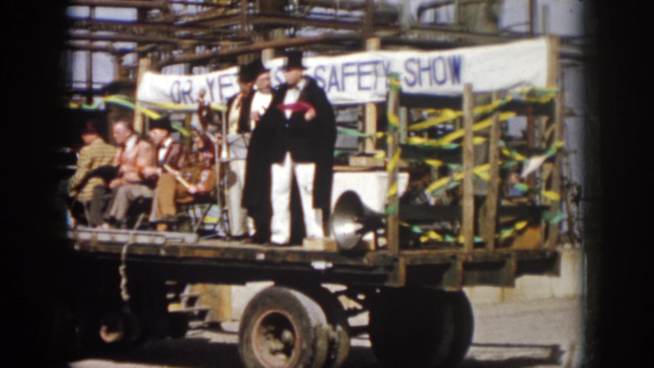 1958 Virginia parade footage showing a flatbed truck with seated people, costumed entertainers, bunting, and a SAFETY SHOW banner.