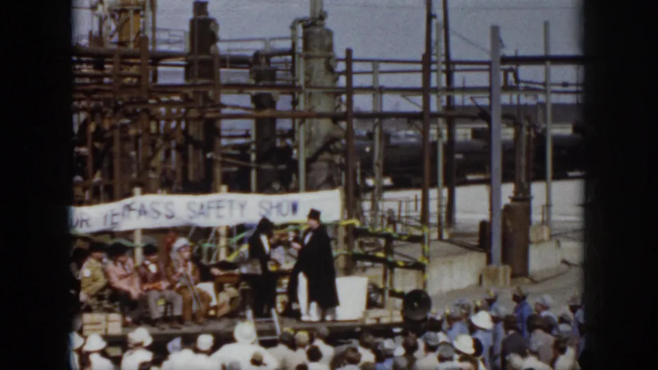 Virginia 1958 industrial safety show with costumed performers on a temporary stage before a crowd.