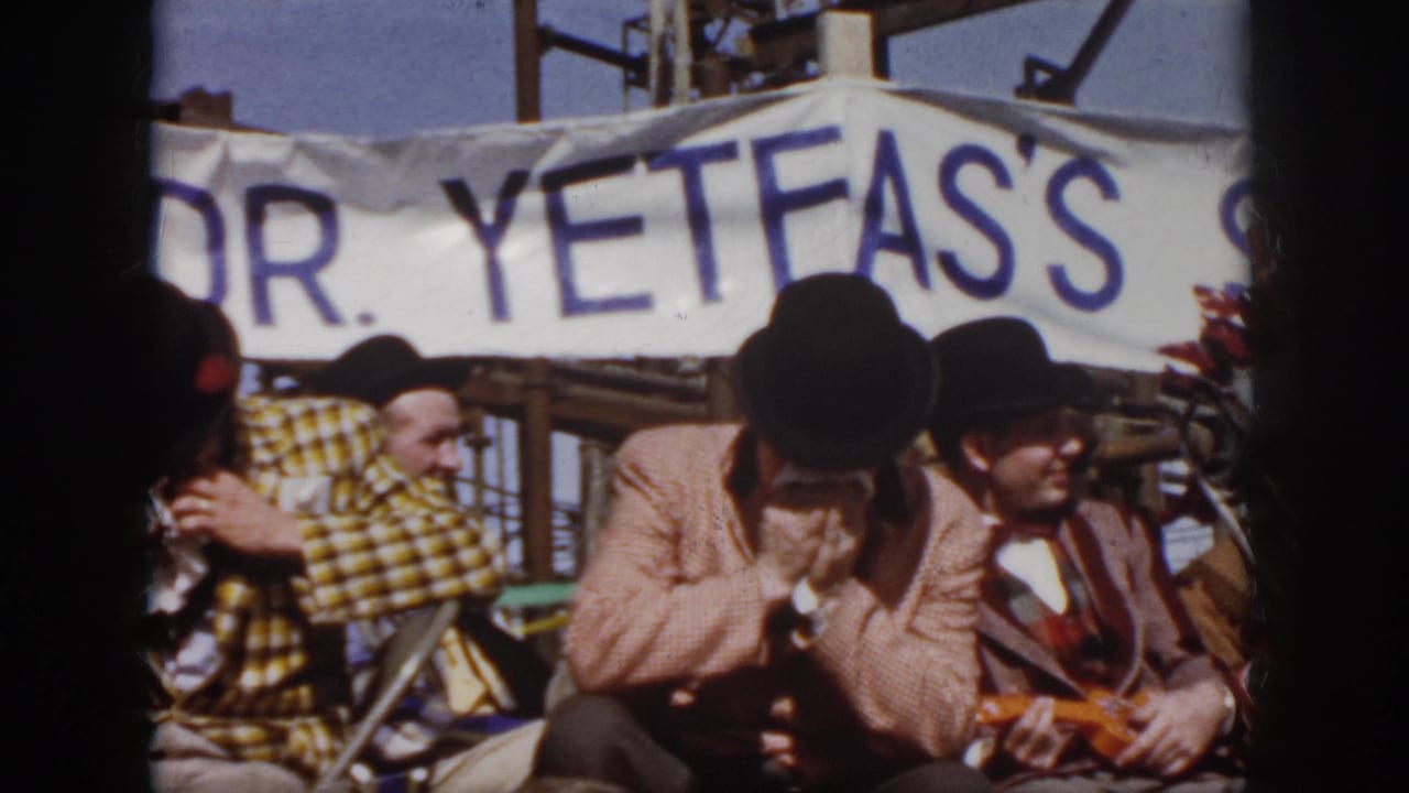 Two top-hatted performers sit beside a harmonica player below the "DR. YETFA'S" banner.