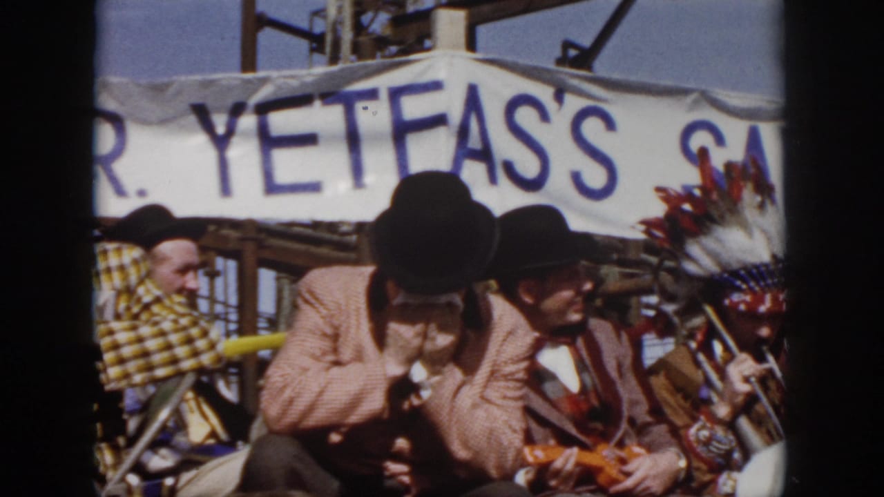1958 Virginia festival frame with a harmonica player, a seated top-hatted musician, and feathered headwear beside the band.