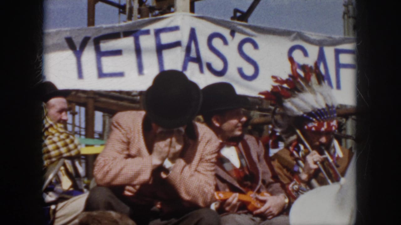 Seated 1958 Virginia festival musicians appear under a blue-lettered banner, with a small stringed instrument visible.