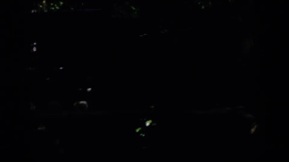 The final frame is almost entirely dark, with only faint scattered light glints and indistinct shapes visible.