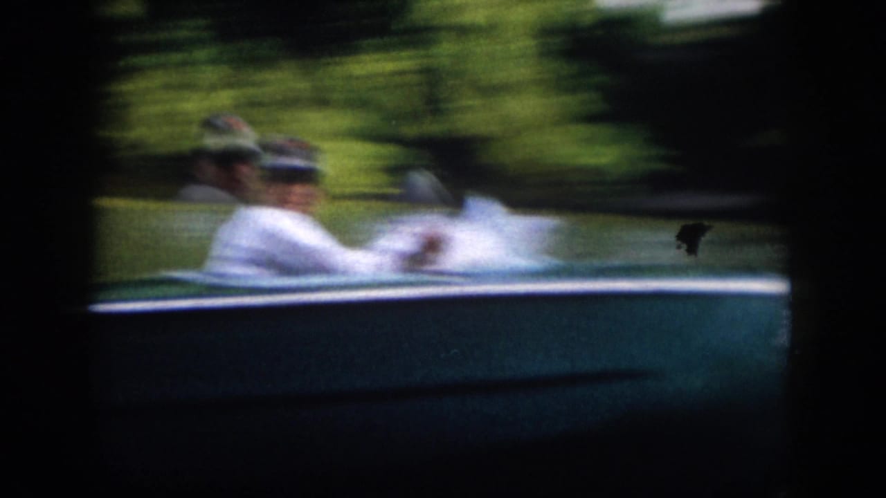 1958 Virginia home-movie frame with a motion-blurred side view of adults seated in a small motorboat as it passes close to camera.