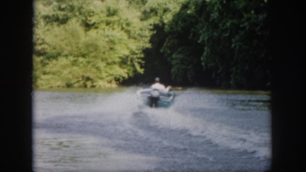 The small motorboat recedes down the tree-lined Virginia river, its wake spreading across the soft, grainy 8mm frame.