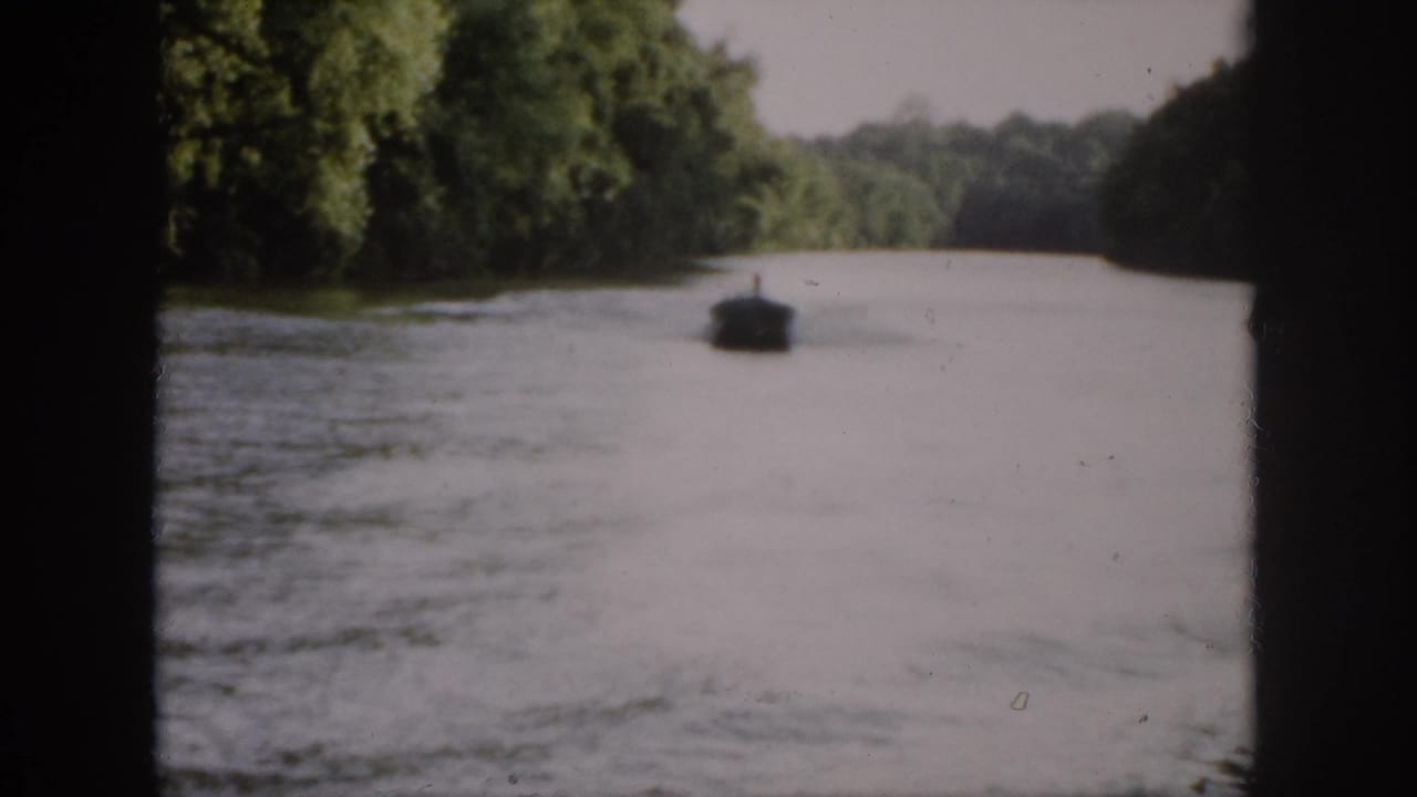 A wider 1958 Virginia river view shows the boat receding down the channel between tree-lined banks.