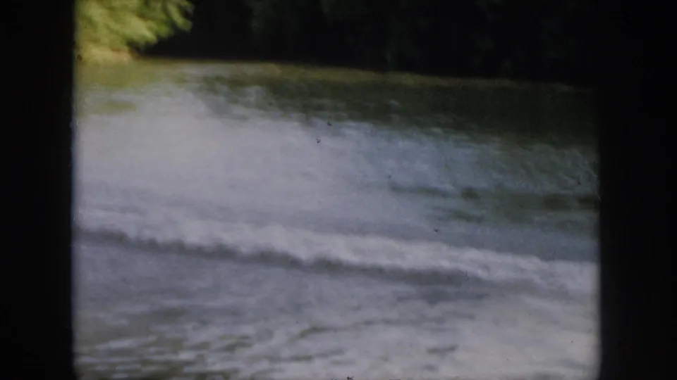 A foamy wake cuts across the river in the 1958 Virginia footage, with trees and dark 8mm gate edges visible.