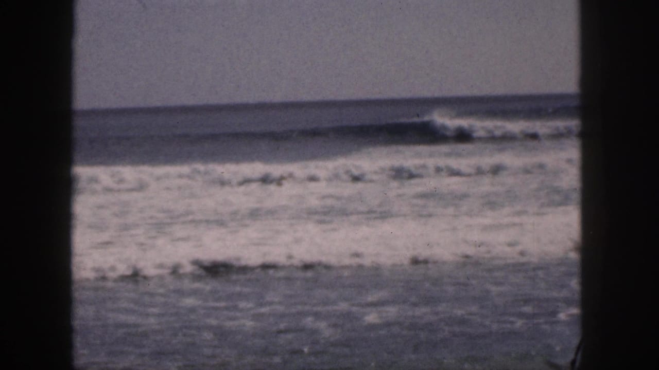 1959 Hawaii coastal view with white surf breaking across gray-blue water behind a dark central frame edge.